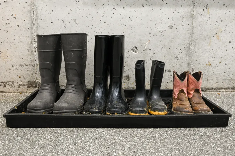 Four pairs of boots in a tray.