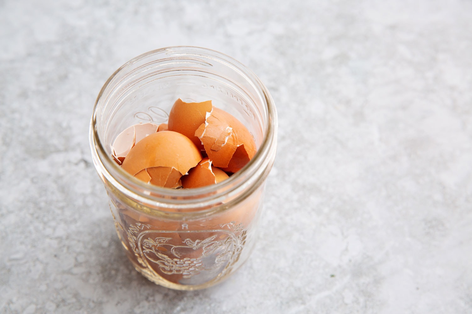 Broken eggshells in a mason jar.